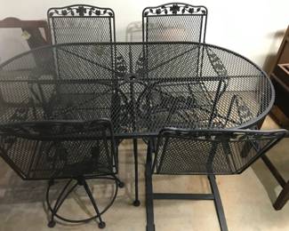 Wrought Iron Patio Set featuring Two Gilders and Two Swivel Chairs.