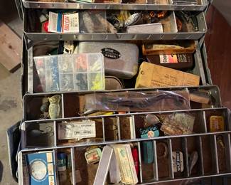 Tackle box loaded with vintage fishing lures and fishing accessories