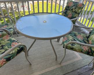 Lot 29 - $150 - Patio Table 40” and 4 Chairs with Pads.  Table has hole for umbrella. 