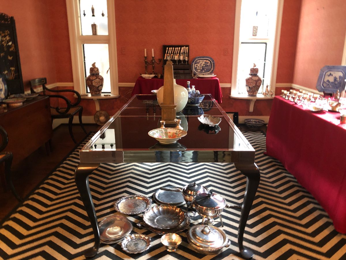 Wonderful custom vintage dining table with steel frame, black wood legs, black glass top and 2 leaves