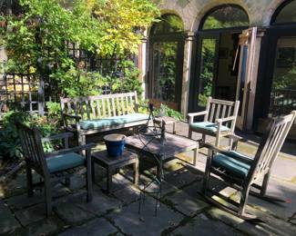 Weathered teak patio furniture in solid condition 