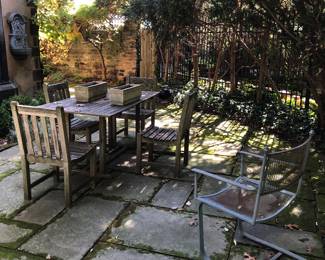 Weathered teak patio furniture in solid condition 