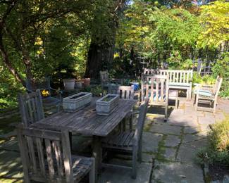 Weathered teak patio furniture in solid condition 