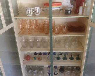 Vintage cabinet filled with depression glass, stemware, and collectibles