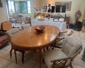 Fruitwood table measures 68.5" x 41.5"  x 39.5", plus 18" leaf and 4 rattan chairs on caster wheels. Beautiful set!!