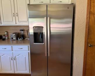 One year old stainless steel side-by-side refrigerator with water and ice in the door