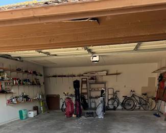 Garage with ladder, tools, lawn & garden, pet gate, and more
