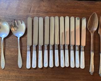 Mother of pearl handled silver knife set with sterling band, and sterling handled wooden salad servers