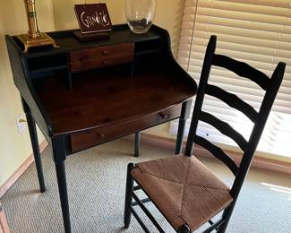 Yield House pine and black lacquer writing desk; woven-seat ladder-back chair.