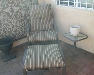 chair and ottoman, small table, planter, rug