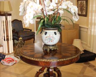 Maitland Smith center hall table with faux orchid arrangement