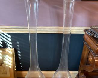 Pair of tall glass vases by Global Views Portugal with glass bowls on top 