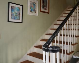 Original art stepping up the main staircase, entrance