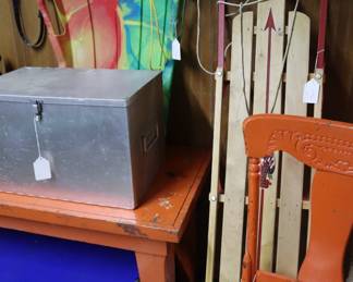 Camping cooking utensils in metal box, sleds, trunk, old kitchen chairs painted orange, Garage