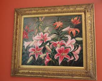 Nicely framed painting of lillies in the sunroom