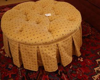 Round large ottoman in center of LR