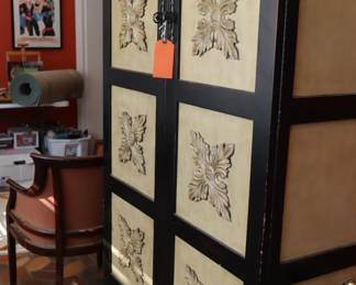 Contemporary, large storage cabinet in black and soft gold, in sunroom