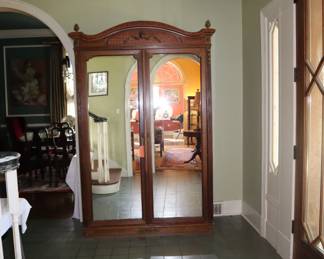 Antique, mirrored door armoire in entrance