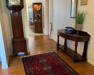 Beautiful entryway into home. Stunning 1780 gothic, mahogany grandfather clock by W North, Leckonfield. Purchased in New Orleans. Gorgeous antique table from England. Clock is H 91" x W 17" x D 9"