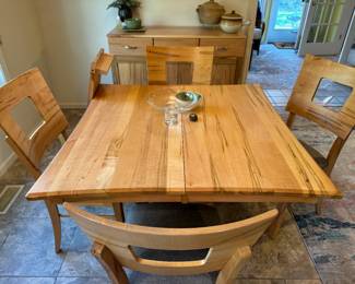 Amish-made, Palettes by Winesburg, wormy maple, contemporary kitchen table with 4 chairs and 1 additional leaf. Set was special ordered from Carter's Furniture in 2020. Homeowner paid $2800 for table and chairs. There is a matching credenza/sideboard as well. One of the best sets we've sold of the year in my opinion, the wormy maple is just stunning. Comes with speciality oil purchased with table. A MUST-SEE! Owner was very sad the set didn't fit into her new home! Look up Palettes by Winesburg to find out more info on this high quality American company.