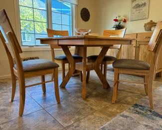 Amish-made, Palettes by Winesburg, wormy maple, contemporary kitchen table with 4 chairs and 1 additional leaf. Set was special ordered from Carter's Furniture in 2020. Homeowner paid $2800 for table and chairs. There is a matching credenza/sideboard as well. One of the best sets we've sold of the year in my opinion, the wormy maple is just stunning. Comes with speciality oil purchased with table. A MUST-SEE! Owner was very sad the set didn't fit into her new home! Look up Palettes by Winesburg to find out more info on this high quality American company.