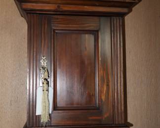 Custom made wooden wall cabinet with lock and key. In Library.