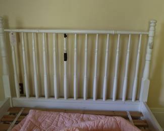 Complete vintage wooden bed with head and footboard in upstairs, northeast bedroom.