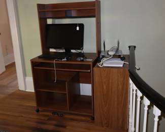 Convenient computer furniture with variety of computer pieces on landing, upstairs.