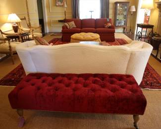 Handsome red velvet bench that could serve as an ottoman coffee table.