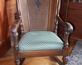 A man's size vintage rocking chair in Library.
