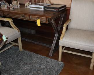 A Hooker casual style writing desk with three drawers. Located in Library.