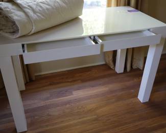 Pure white, as in all things Apple, a lacquered writing desk with two drawers shown partially pulled out, very chic! This is in the upstairs bedroom on the northeast corner. 