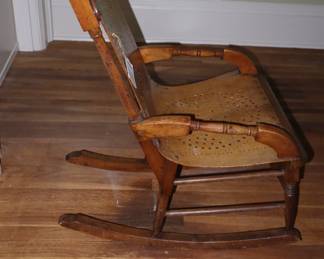 Tiny, handmade rocker, but adult size. Upstairs on landing. 
