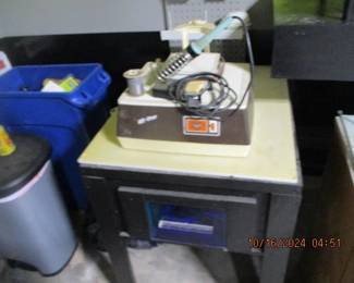 Stained glass set up with glass cutter, light table, stained glass, and accessories