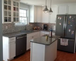 White kitchen cabinets with granite countertops