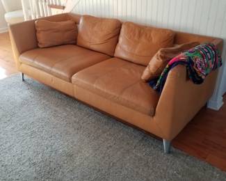 Contemporary couch in a pumpkin hue