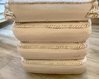 signed ceramic stool shaped like stacked pillows