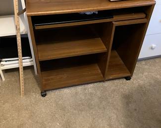 Compact desk on rollers with pull out keyboard tray.