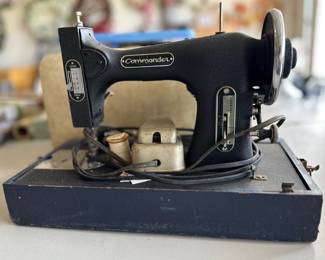 Commodore sewing machine with lid and wooden base.