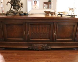 A stately sideboard from Scandinavia was hand carved of oak about 1920