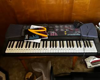 Casio keyboard with instructions and various music books