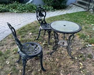 outdoor table and black wrought iron chairs