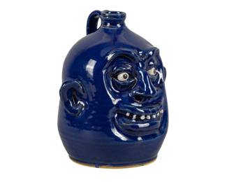 Marvin Bailey 20th century, America, stoneware face jug with dark blue glaze, signed underfoot