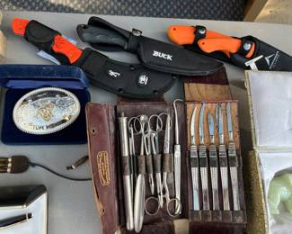 Vintage surgical kit; Safari Club International “Life Member” belt buckle; knives with sheaths by Browning, Sportsmen’s Alliance and Buck.