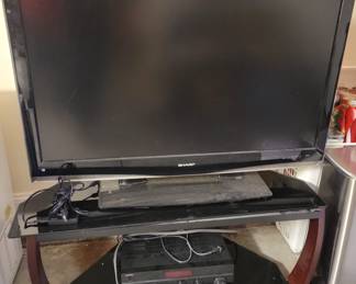 Sharp flat screen TV and TV stand