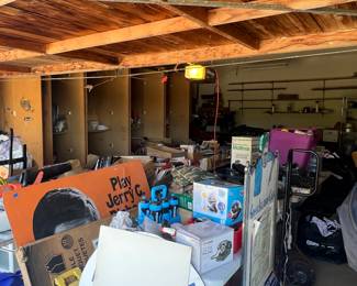 Garage full of restaurant and catering items, sport equipment, hockey gear.  