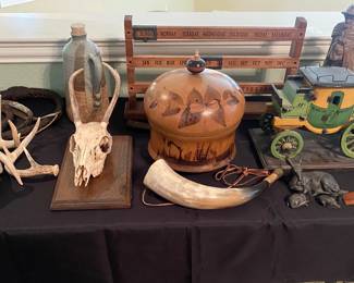 Small deer skull & horns 
WOOD sewing box
Handmade wood stagecoach
Sliding calendar
Pottery
Braided leather whip
