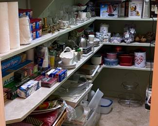 This pantry is full of serving pieces, organizational supplies, glassware, small appliances, and so much more