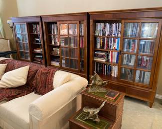 Ethan Allen Regency style bookcase with sliding glass doors and  beautiful details! Most of the books are biographies on just about anyone that you can think of. 