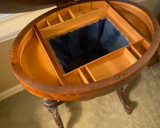 Opened Victorian oval top lift storage cabinet. 